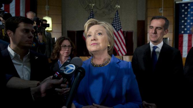 Democratic presidential candidate Hillary Clinton, joined by Los Angeles Mayor Eric Garcetti, right, pauses as she talks to media after a roundtable with Muslim community leaders at the University of Southern California in Los Angeles, Thursday, March 24, 2016. (AP Photo/Carolyn Kaster)