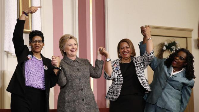 Democratic presidential candidate Hillary Clinton, stands with. from left, Geneva Reed-Veal, Annette Holt and Rep. Gwen Moore, D-Wis., after attending a forum on gun violence, Tuesday, March 29, 2016, at the Tabernacle Community Baptist Church in Milwaukee. (AP Photo/Patrick Semansky)