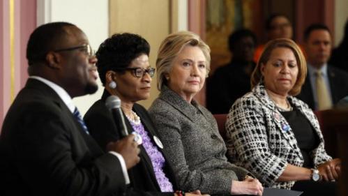 Democratic presidential candidate Hillary Clinton attends a forum on gun violence, Tuesday, March 29, 2016, at the Tabernacle Community Baptist Church in Milwaukee. From left are, Pastor Don Darius Butler, Geneva Reed-Veal and Annette Holt. (AP Photo/Patrick Semansky)