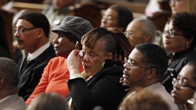 A woman wipes her eyes as she listens to a forum on gun violence featuring Democratic presidential candidate Hillary Clinton, Tuesday, March 29, 2016, at the Tabernacle Community Baptist Church in Milwaukee. (AP Photo/Patrick Semansky)