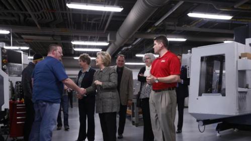 Democratic presidential candidate Hillary Clinton shakes hands with student Paul Stacey as she tours Western Technical College in La Crosse, Wis., Tuesday, March 29, 2016. (AP Photo/Patrick Semansky)