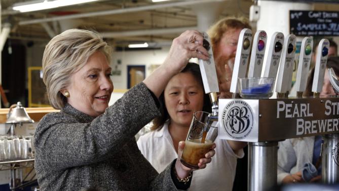 Democratic presidential candidate Hillary Clinton pours a beer during a tour of Pearl Street Brewery in La Crosse, Wis., Tuesday, March 29, 2016. (AP Photo/Patrick Semansky)