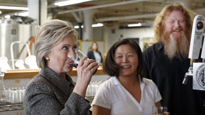 Democratic presidential candidate Hillary Clinton sips a beer during a tour of the Pearl Street Brewery in La Crosse, Wis., Tuesday, March 29, 2016. (AP Photo/Patrick Semansky)