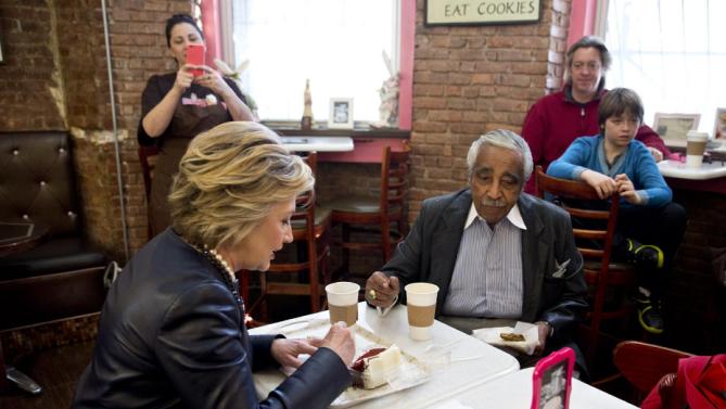 Democratic presidential candidate Hillary Clinton, right, has coffee and cake with Rep, Charles Rangel, D-N.Y. during a campaign stop at the Make My Cake bakery, Wednesday, March 30, 2016, in the Harlem neighborhood of New York. (AP Photo/Mary Altaffer)