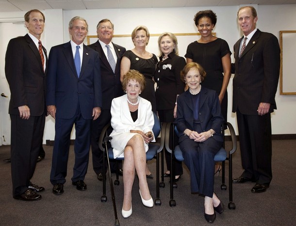 (Top row from L to R) Mike Ford, former U.S. president George W. Bush, Jack Ford, Susan Ford Bales, former first lady and U.S. Secretary of State Hillary Rodham Clinton, U.S. first lady Michelle Obama and Steve Ford stand as former first lady Nancy Reagan (in white) and former first lady Rosalynn Carter sit as they gather for a photo before the funeral of former first lady Betty Ford at St. Margaret's Episcopal Church Tuesday in Palm Desert, California July 12, 2011. Betty Ford was remembered at a memorial service in California on Tuesday as a mother, first lady, friend and "tireless advocate for those struggling". Ford, wife of late President Gerald Ford who helped found a rehabilitation clinic that bears her name, died on Friday at the age of 93.  REUTERS/Gerald R. Ford Library and Museum, David Hume Kennerly/Pool (UNITED STATES - Tags: POLITICS OBITUARY)