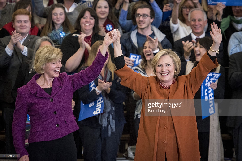 Hillary Clinton, former Secretary of State and 2016 Democratic presidential candidate, right, is joined on stage by Senator Tammy Baldwin, a Democrat from Wisconsin, during a campaign event in Eau Claire, Wisconsin, U.S., on Saturday, April 2, 2016. Clinton used Donald Trump's remarks about punishing women who have abortions if the procedure were outlawed to level a double-barreled attack on the Republican front-runner as well as her Democratic rival, Bernie Sanders. Photographer: Christopher Dilts/Bloomberg *** Local Caption *** Hillary Clinton; Tammy Baldwin