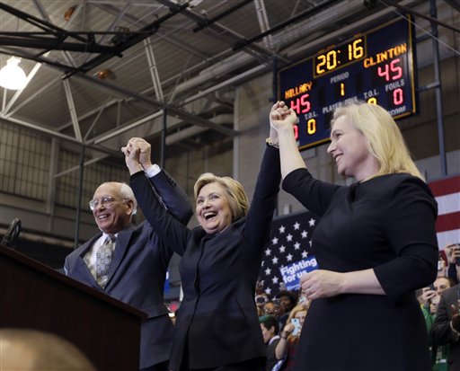 Democratic presidential candidate Hillary Clinton, center, stands with Rep. Paul Tonko, D-N.Y., and Sen. Kirsten Gillibrand, D-N.Y.,  after speaking at a rally at Cohoes High School on Monday, April 4, 2016, in Cohoes, N.Y. (AP Photo/Mike Groll)