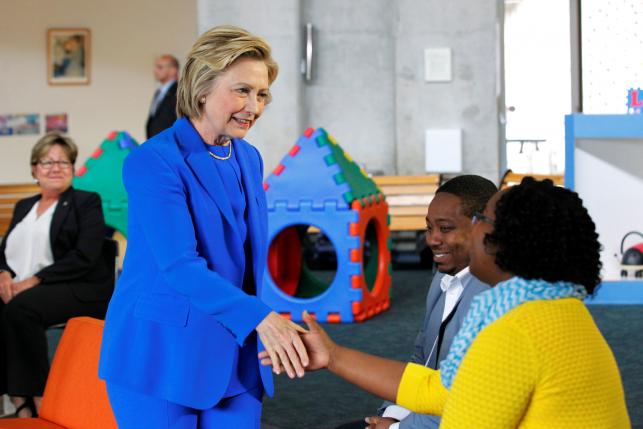 U.S. Democratic presidential candidate Hillary Clinton shakes hands with parents during a campaign event, "Conversation with Young Parents in the Workforce" at The Family Care Center in Lexington, Kentucky, U.S., May 10, 2016. REUTERS/John Sommers II