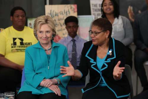 © Monica Almeida/The New York Times Hillary Clinton and Representative Karen Bass of Los Angeles gathered with a group of families and residents to discuss foster care at a union headquarters in…