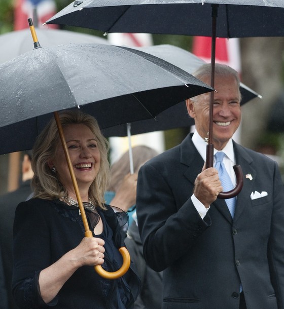 US Vice President Joe Biden and Secretary of State Hillary Clinton smile as US President Barack Obama welcomes South Korean President Lee Myung-bak during a State Arrival Ceremony on the South Lawn of the White House in Washington, DC, on October 13, 2011. Obama hosts his South Korean counterpart for a full day of official State ceremonies, including a State Dinner. AFP PHOTO / Saul LOEB (Photo credit should read SAUL LOEB/AFP/Getty Images)