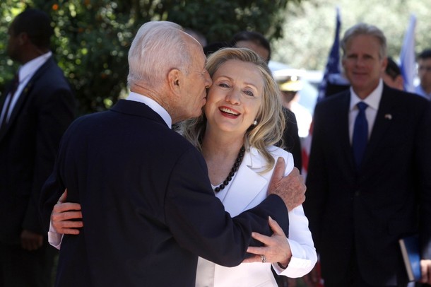 JERUSALEM, ISRAEL - JULY 16: (ISRAEL OUT) Israeli President Shimon Peres (L) kisses US Secretary of State Hillary Clinton before their meeting on July 16, 2012 in Jerusalem, Israel. Clinton is in Israel to discuss diplomacy with Iran, Syria and Egypt in addition to peace talks regarding the Middle East. (Photo by Lior Mizrahi/Getty Images)